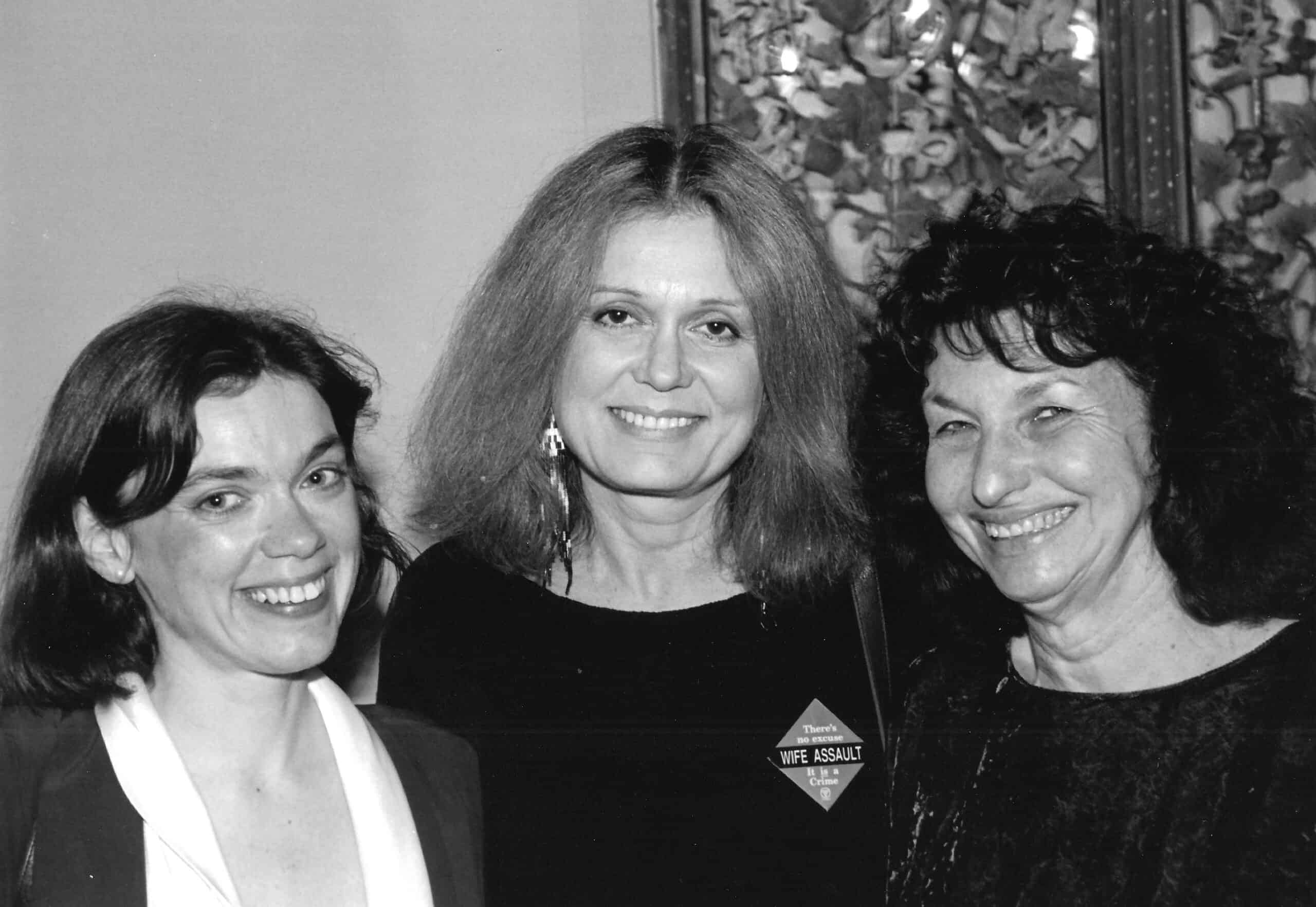 Black and white photo of three smiling women